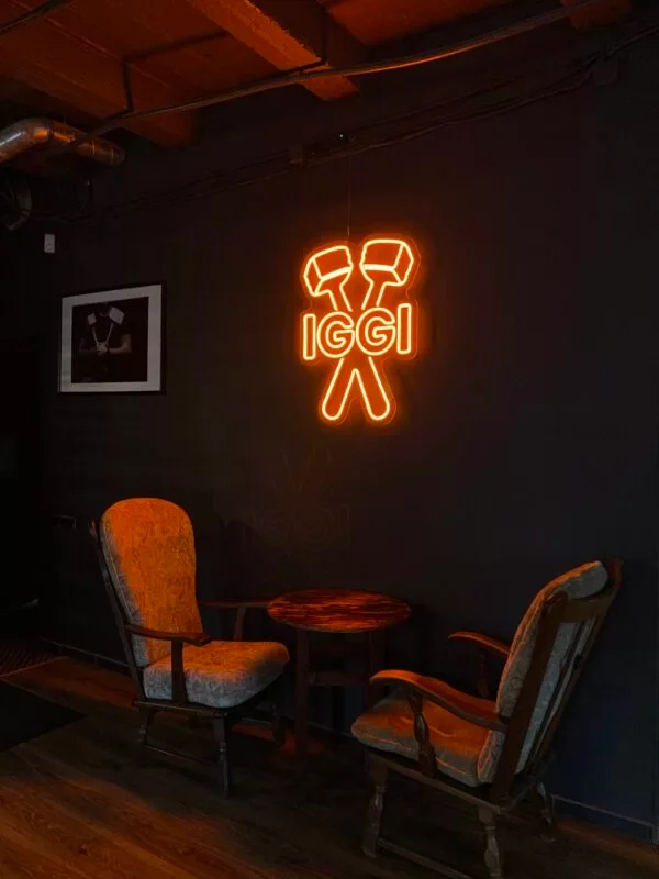 Orange LED neon logo glowing in a dark restaurant corner