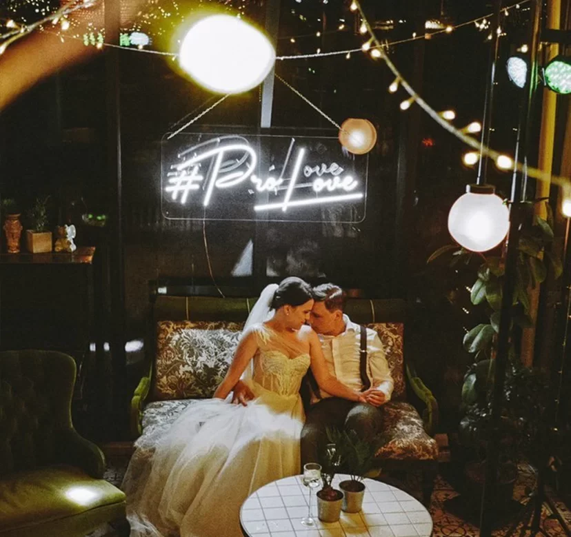 White LED neon hashtag sign at an evening wedding