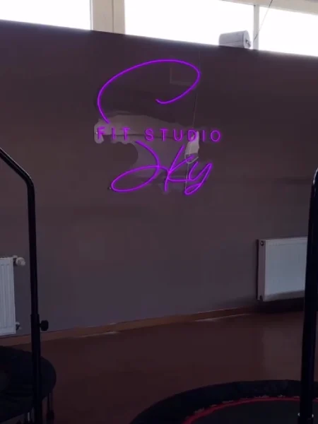 Purple LED neon script sign in a yoga studio