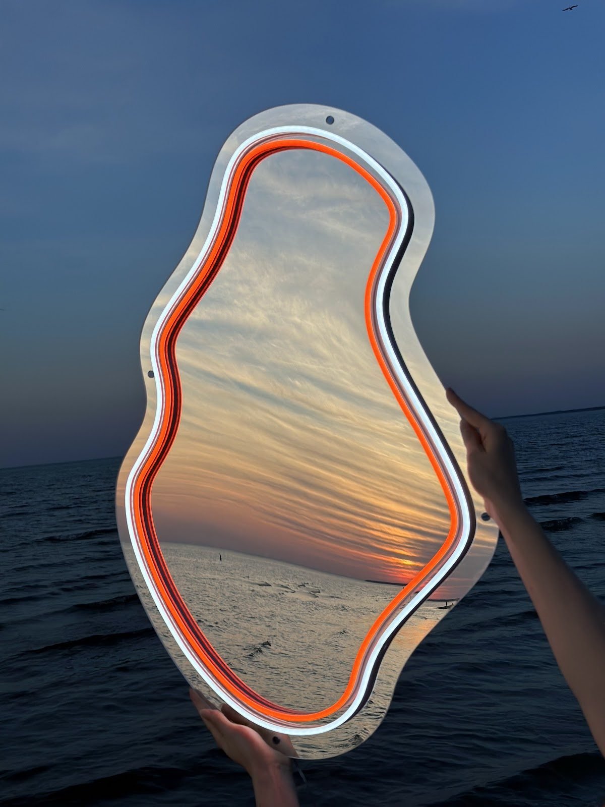 Mirror with an orange LED neon outline