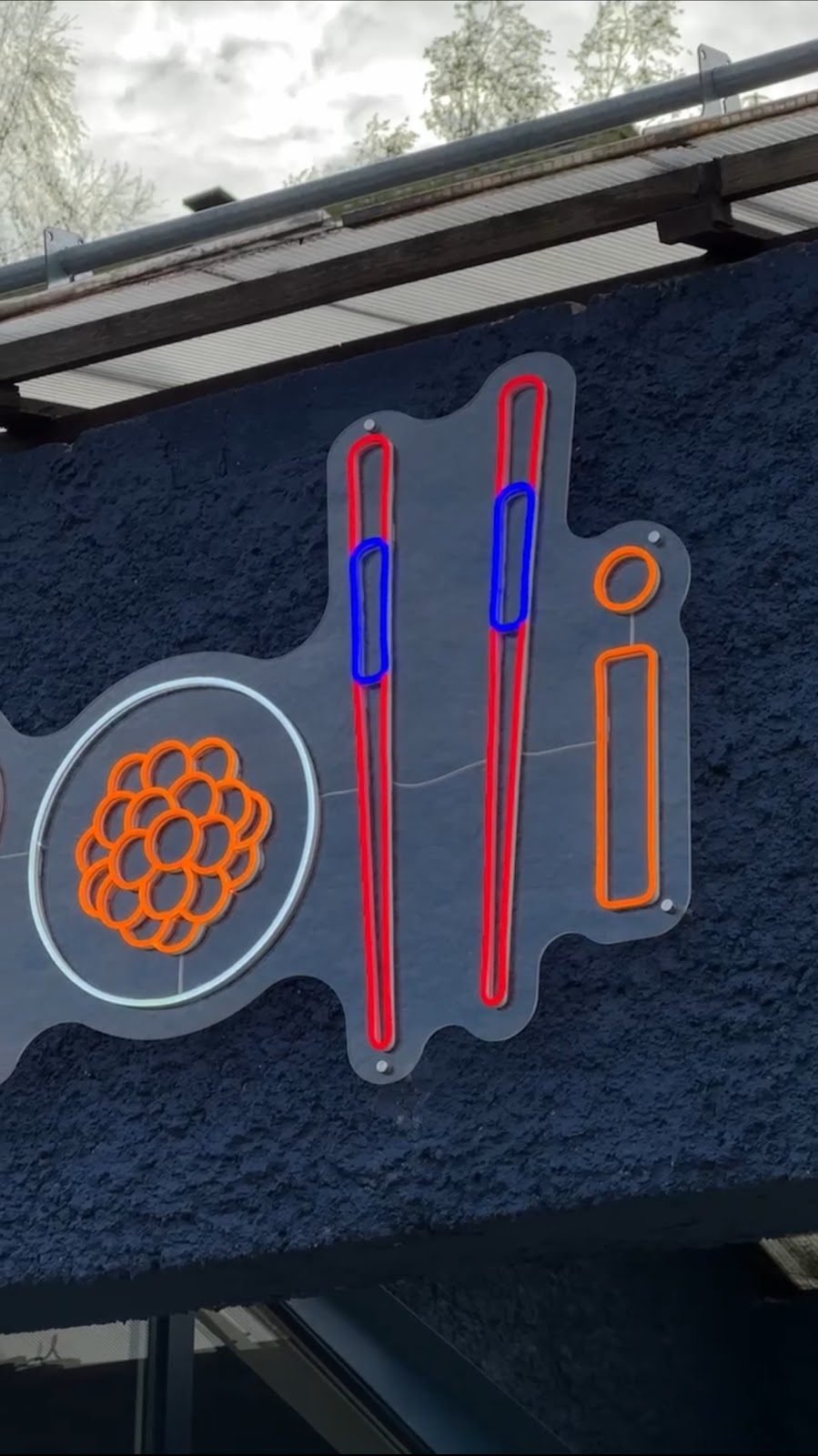 Restaurant sign in coloured LED neon on a facade