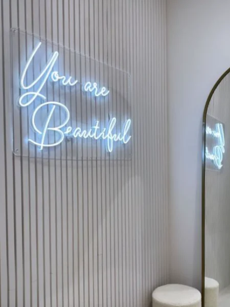 White LED neon You are Beautiful sign beside a mirror