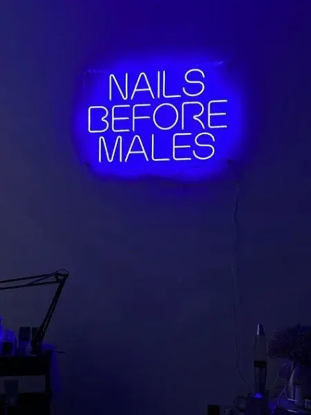Blue LED neon Nails Before Males sign in a nail salon