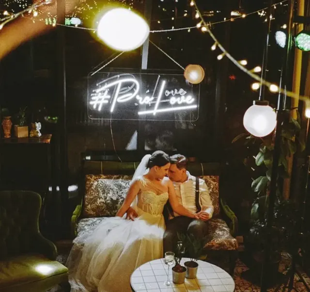 White LED neon hashtag sign at an evening wedding