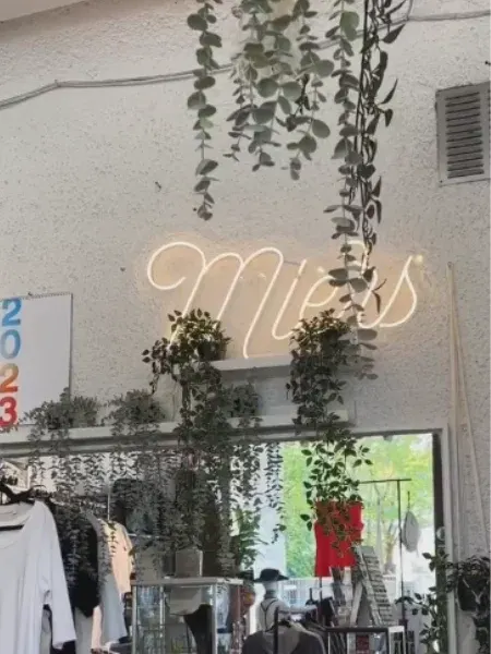 Warm white LED neon script logo in a boutique
